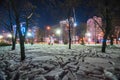 Snowy footprints in night illuminated park Royalty Free Stock Photo