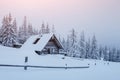 Snowy forest in the Carpathians. A small cozy wooden house covered with snow. The concept of peace and winter recreation Royalty Free Stock Photo