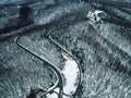 Snowy forest and road. Aerial view from a drone Royalty Free Stock Photo