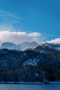 Snowy forest on the shore of Black Lake at the foot of the misty mountains. Durmitor National Park, Montenegro Royalty Free Stock Photo