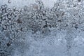 Snowy frosty pattern as large accumulation of small unusual snowflakes on winter window. Royalty Free Stock Photo