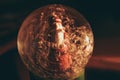 Snowy glass ball with Santa Claus inside, which reflects the burning candle Royalty Free Stock Photo