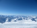 Snowy Greater Caucasus ridge with the Mt. Ushba at winter sunny day. View from Pastuchova kliffs at Elbrus ski slope