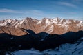 Snowy Greater Caucasus ridge. Sunny day. Before suset. View from 3500m Royalty Free Stock Photo