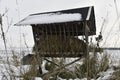 A snowy hay rack in the winter. Feeding rack filled with hay and ready for winter wildlife feeding. Concept of the end