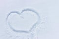 Snowy heart on the winter surface. Big cold heart painted in the snow Royalty Free Stock Photo