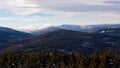 Snowy hilly landscape view from above with clouds rolling over the ridge, Jeseniky Royalty Free Stock Photo