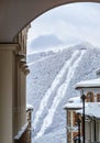 Snowy hotel roofs of Gorky Gorod winter mountain ski resort on snowy ski slope and ski lift background. Beautiful scenic landscape Royalty Free Stock Photo