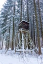 Snowy hunting high gamekeeper hidden in the middle of the forest.