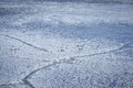 Snowy ice surface with cracks in blue shades and vignette Royalty Free Stock Photo