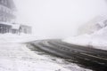 Snowy and icy road curve in a foggy weather - Vosges mountains Royalty Free Stock Photo