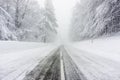 Snowy and icy road in foggy weather Royalty Free Stock Photo