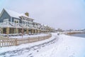 Snowy landscape with lakefront homes in Daybreak