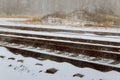In a snowy landscape on a railroad in the winter, the rails are covered with snow Royalty Free Stock Photo