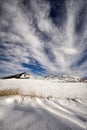 Snowy landscape on a sunny day and spectacular clouds