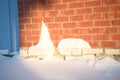 Snowy landscapes and snow close-up in sunbeams. Grass and objects in the snow