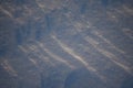 Snowy landscapes and snow close-up in sunbeams. Grass and objects in the snow