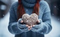 Snowy Love Young Girls Hands Holding Heart. Hands in mittens holding a snow heart in the snow Royalty Free Stock Photo