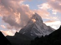 Snowy matterhorn overlooking the valley at dusk Royalty Free Stock Photo