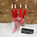 Snowy Merry Christmas : four red burning candles with bow and me