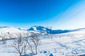 Snowy mountain and blue sky in Norway on a sunny winter day Royalty Free Stock Photo