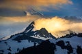 Snowy mountain and clouds illuminated by setting sun