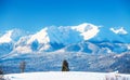 Snowy mountain landscape. Natural background for ski resorts. White mountain peaks and hills covered with snow on a bright winter Royalty Free Stock Photo