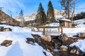 Snowy mountain landscape with a small brige over a creek in foreground Royalty Free Stock Photo