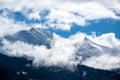 Snowy mountain peaks in Austria in the clouds. Royalty Free Stock Photo