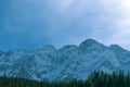 Snowy mountain peaks. Mountain landscape. Winter in the mountains. Blue sky. Spruce forest. White snow. Nature. Royalty Free Stock Photo