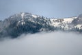 Snowy Mountain Peaks Standing Above the Clouds Royalty Free Stock Photo