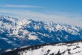 Snowy mountain peaks in the Zell am See area of Austria. In the background is a blue sky with dramatic clouds Royalty Free Stock Photo