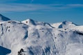 Snowy mountain peaks in the Zell am See area of Austria. In the background is a blue sky with dramatic clouds Royalty Free Stock Photo