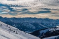 Snowy mountain peaks in the Zell am See area of Austria. In the background is a blue sky with dramatic clouds Royalty Free Stock Photo