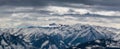 Snowy mountain peaks in the Zell am See area of Austria. In the background is a blue sky with dramatic clouds Royalty Free Stock Photo