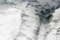 Snowy mountain ridges. Top view from the airplane Royalty Free Stock Photo