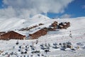 Snowy mountain skiing village, falling snow