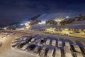 Snowy mountain skiing village at night