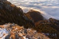 Snowy mountain slope above clouds at the sunrise Royalty Free Stock Photo