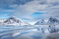 Snowy mountains and blue sky with clouds reflected in water Royalty Free Stock Photo