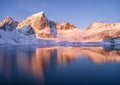 Snowy mountains and blue sky reflected in water at sunset Royalty Free Stock Photo