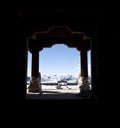 Snowy mountains through a buddhist monastery door Royalty Free Stock Photo