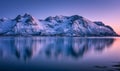 Snowy mountains and colorful sky reflected in water at sunset Royalty Free Stock Photo