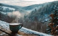 snowy mountains with cup of steamy hot milky coffee on a wooden deck Royalty Free Stock Photo