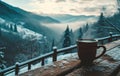 snowy mountains with cup of steamy hot milky coffee on a wooden deck Royalty Free Stock Photo