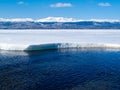 Snowy Mountains at frozen Lake Laberge, Canada Royalty Free Stock Photo