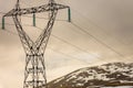 Snowy mountains with high voltage post