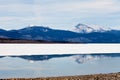 Snowy Mountains mirrored on Lake Laberge, Yukon Royalty Free Stock Photo