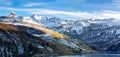 Snowy mountains in northern french Alps. with a lake. with a blue sky and clouds Royalty Free Stock Photo