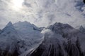 Snowy Mountains peaks in the clouds blue sky Caucasus